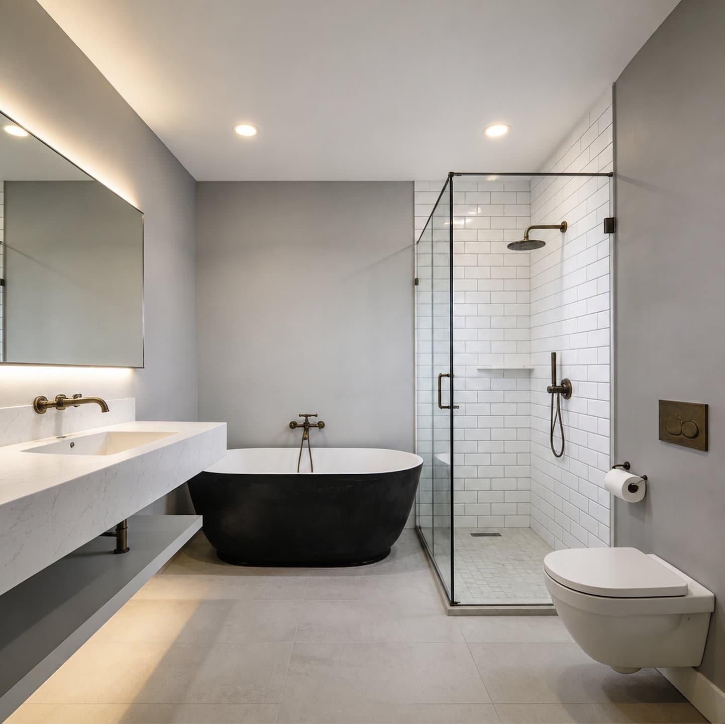Walk-in shower with a frameless glass enclosure and brass fixtures in a completed bathroom remodel
