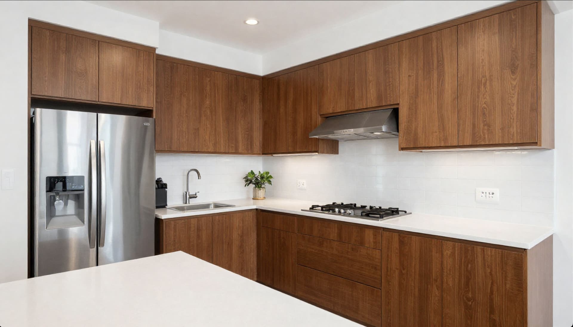 Kitchen remodel with walnut shaker cabinets and white quartz countertops in Doral, Miami-Dade County, FL by Gaven Constructions