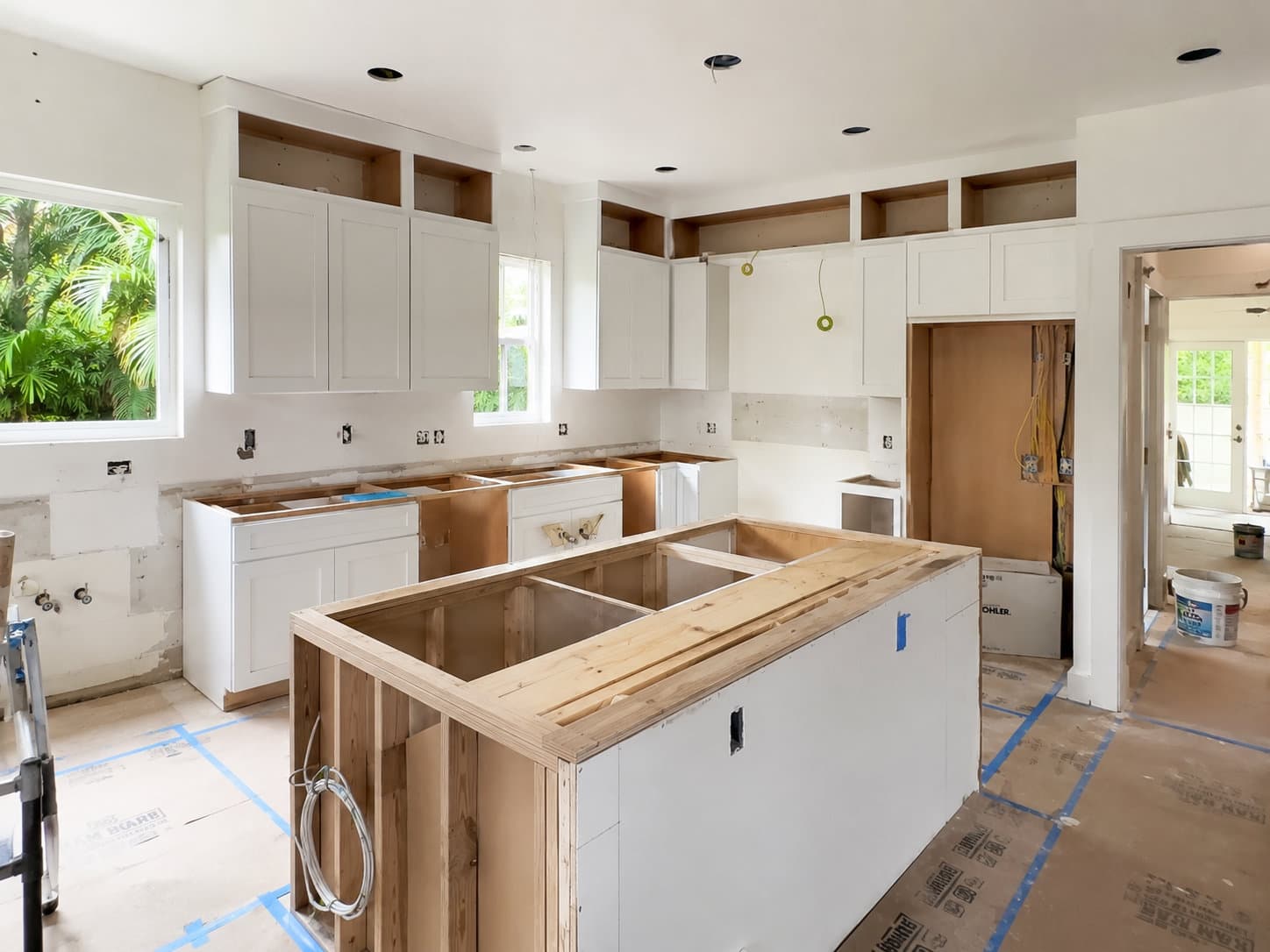 Tier 03 Miami kitchen appliance package install with factory-certified installer working on Sub-Zero refrigeration column — Gaven Constructions license CGC1524886