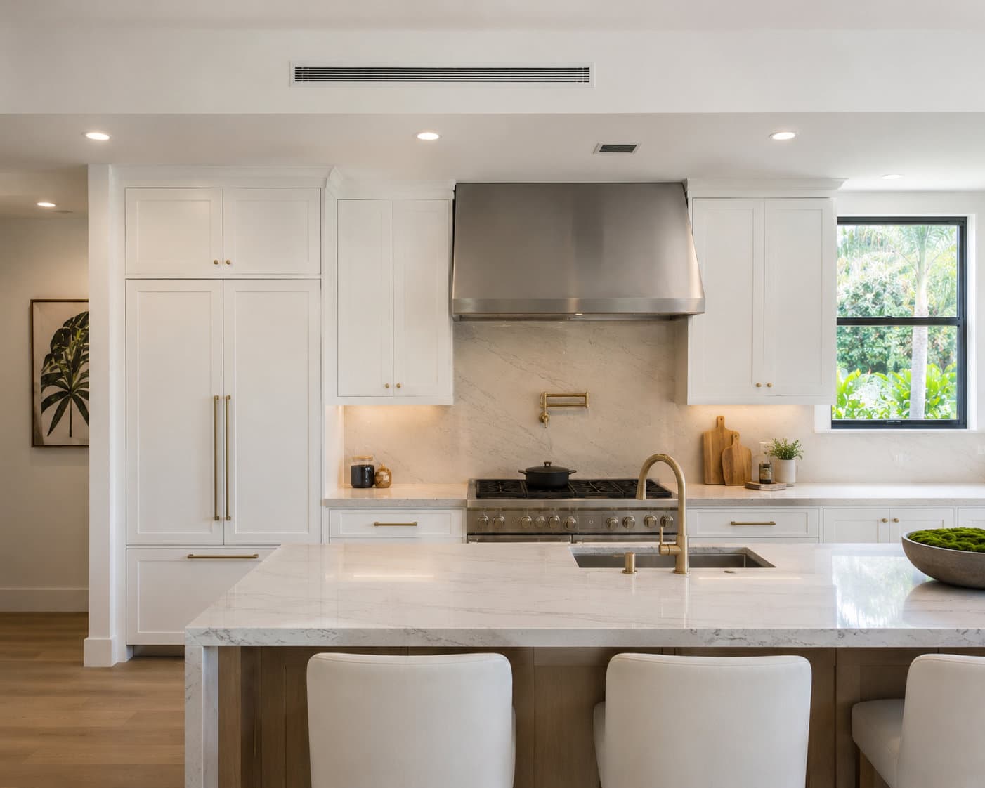 Tier 04 Miami kitchen with Sub-Zero integrated refrigeration columns and book-matched stone — Gaven Constructions ultra-luxury custom remodel