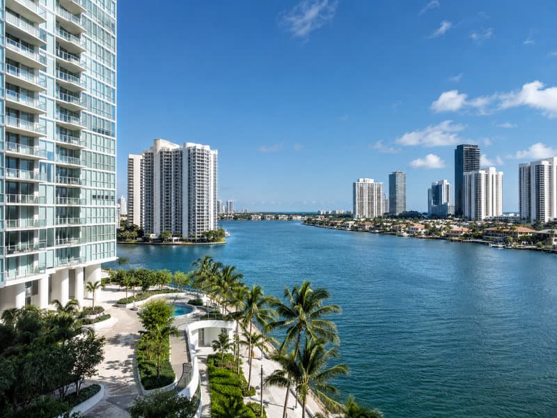 Aventura coastline with luxury high-rise tower stock visible, working construction market