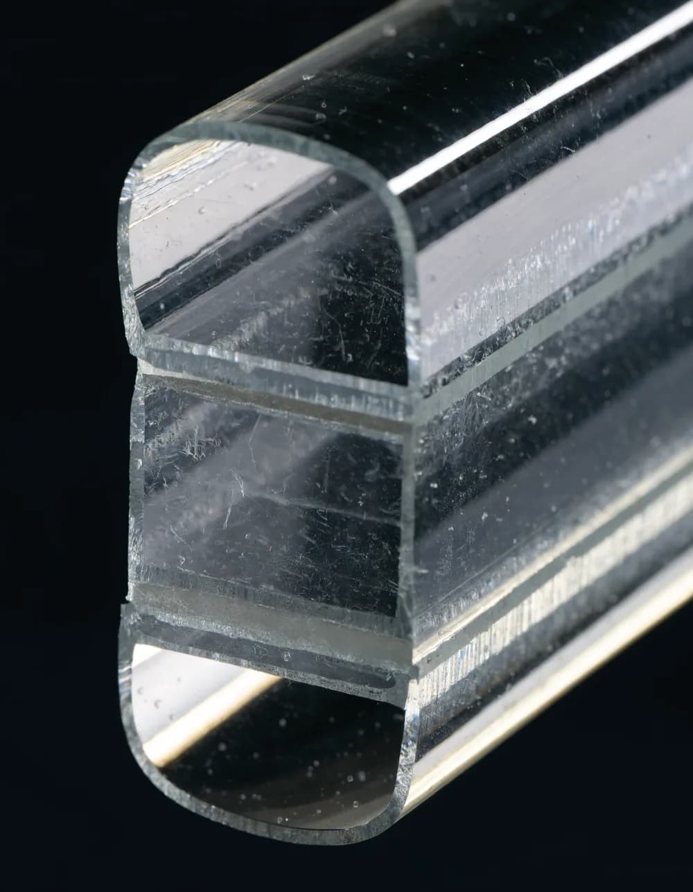 Cross-section of laminated impact glass showing the interlayer that holds the pane together on impact