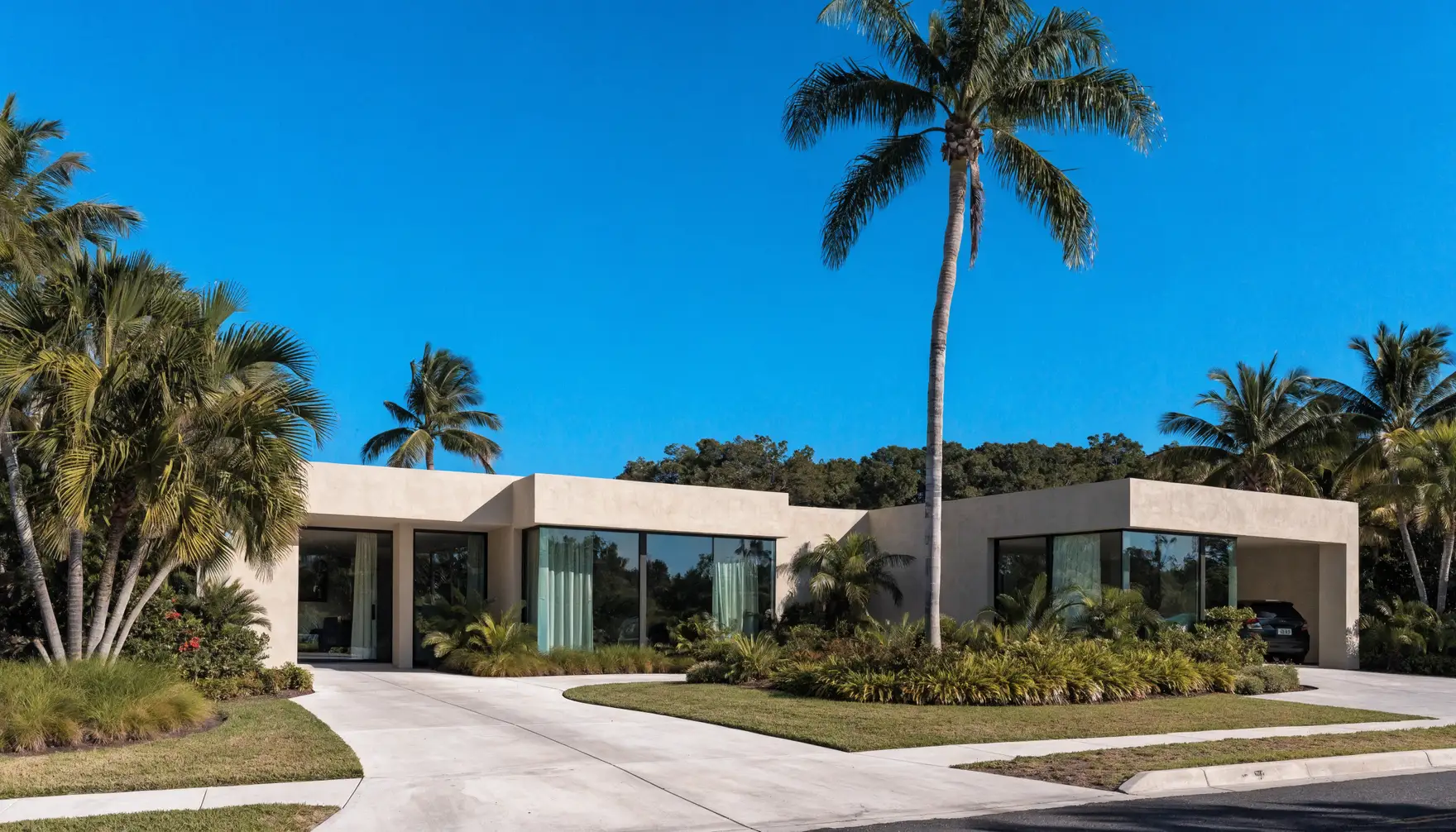 Impact-rated windows and doors on a South Florida home exterior under a clear sky