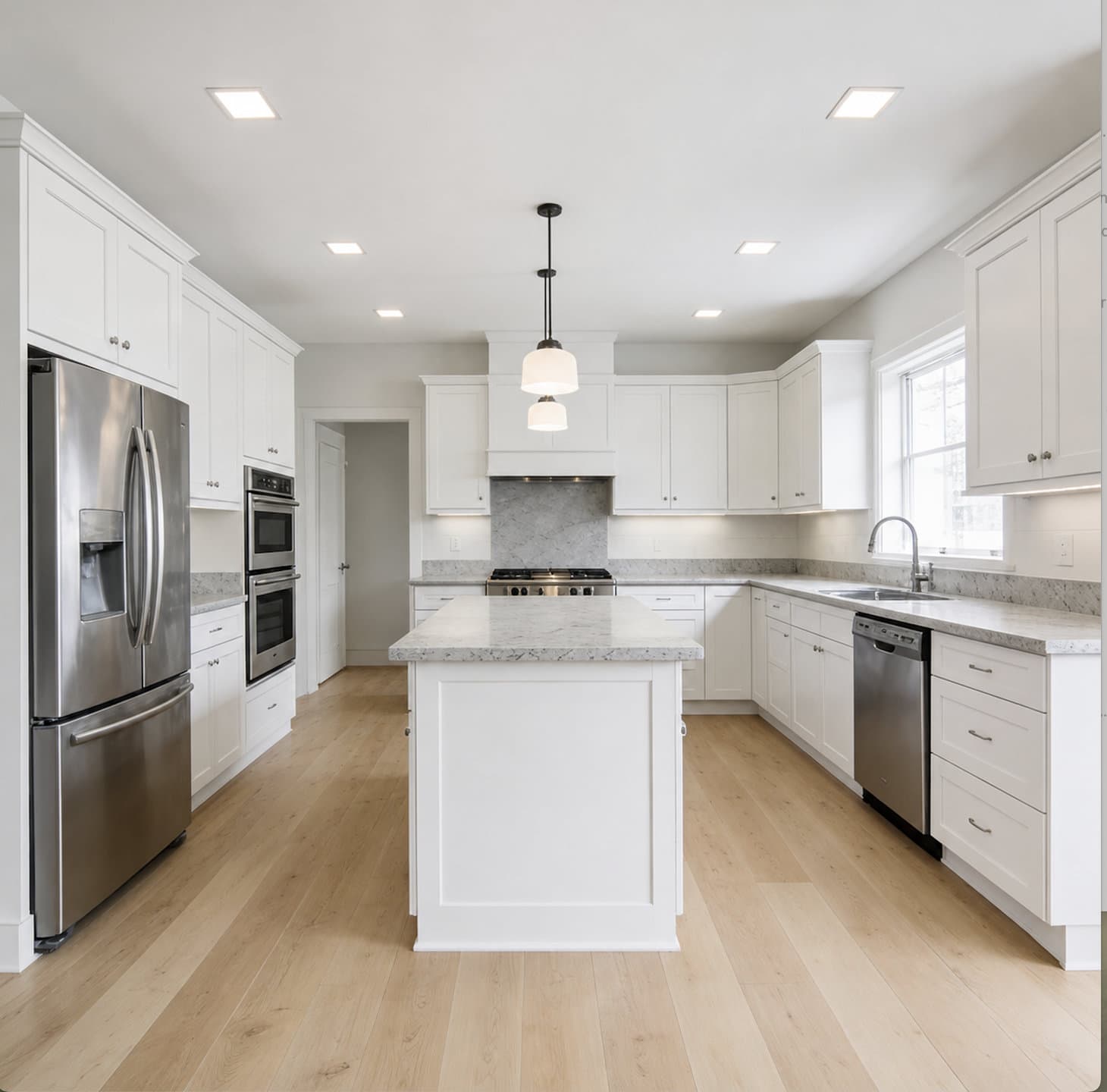 White kitchen with recessed ceiling lights and island pendants, Broward County