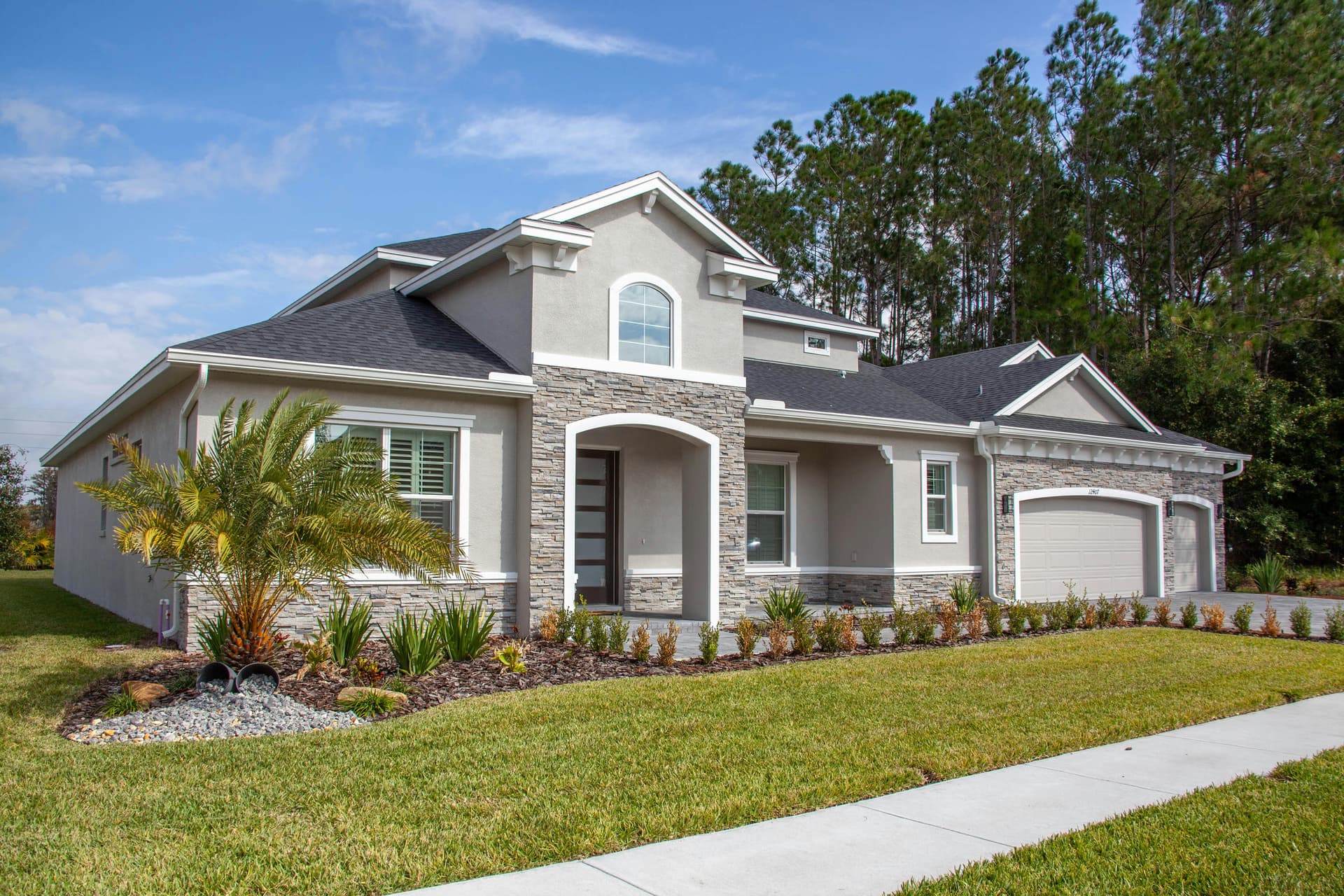 Single-family residential exterior on a Miami-Dade or Broward lot, completed elevation, daylight