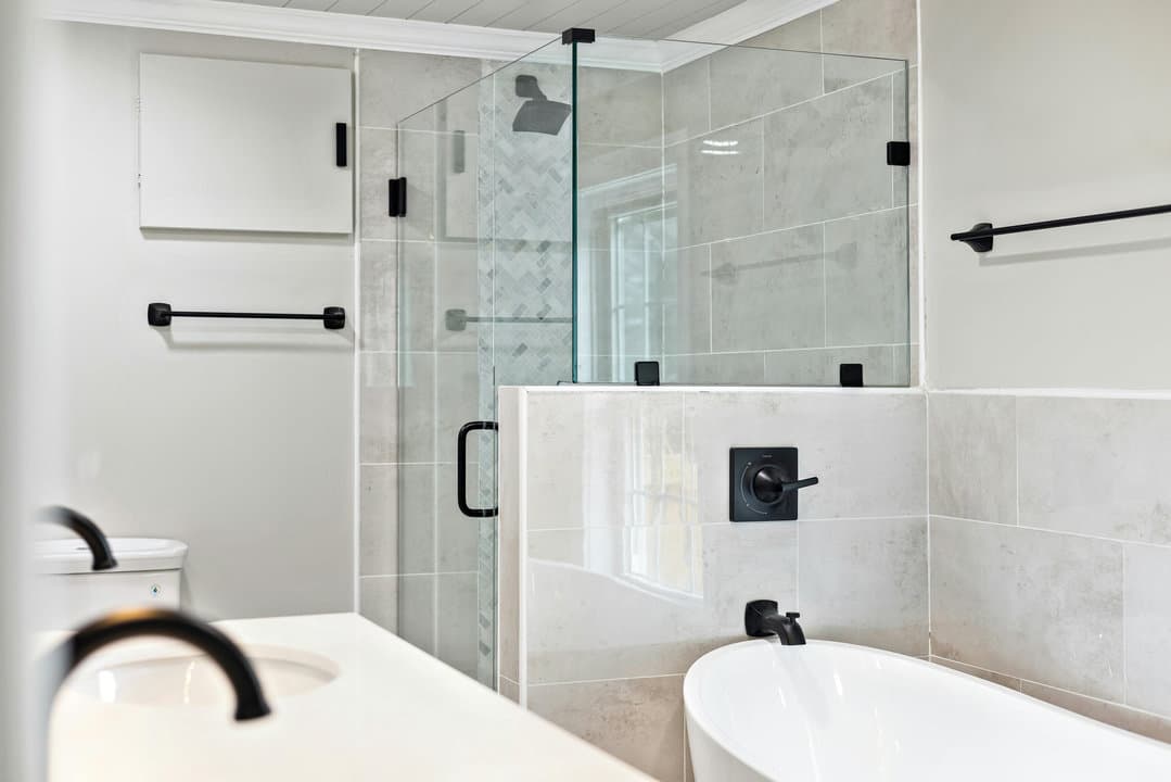 Hollywood guest bathroom remodel — low-threshold alcove shower with ceramic subway-tile surround, replacing original 1960s cast-iron tub
