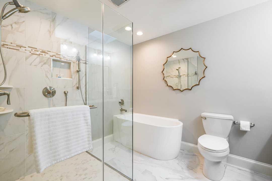 Pembroke Pines primary bathroom remodel — floor-to-ceiling large-format porcelain with walk-in shower behind a long frameless glass wall