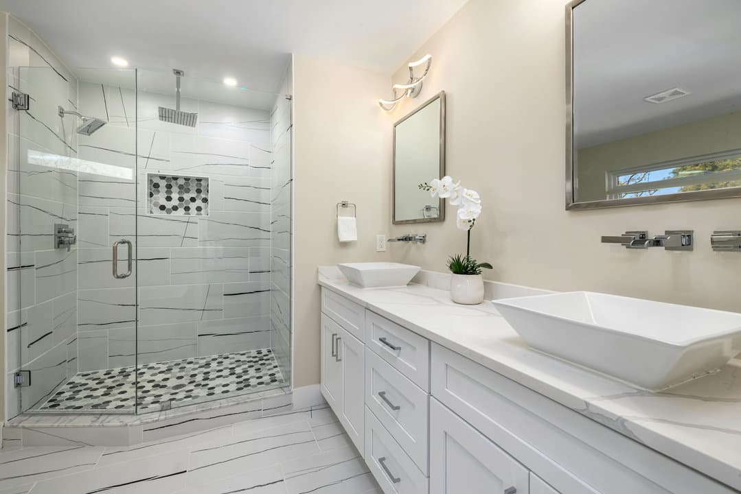 Pinecrest primary bathroom remodel — curbless walk-in shower with linear drain, freestanding tub, large-format porcelain floor and walls
