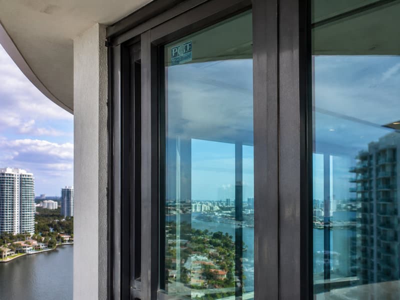 HVHZ-rated impact glass assembly on Aventura tower facade with Miami-Dade Notice of Acceptance documentation