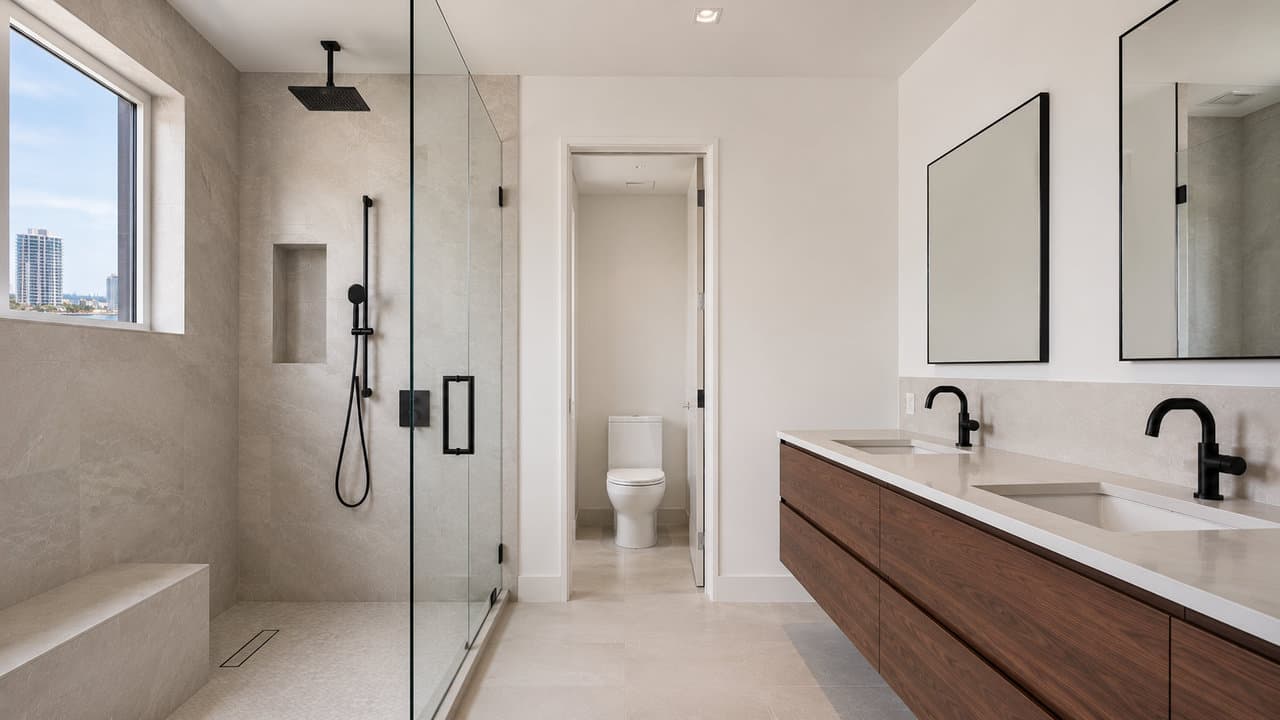 Williams Island tower primary bathroom remodel — frameless glass shower and freestanding tub