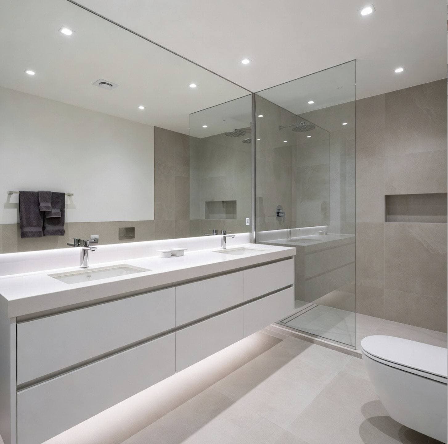 Completed bathroom remodel with a floating wood vanity and a frameless glass walk-in shower