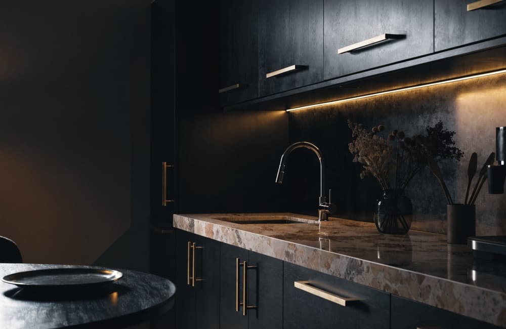 Completed Miami kitchen with flat-panel cabinetry, a stone counter run and under-cabinet lighting.